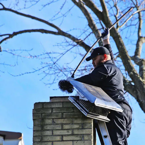 Illustrative rooftop chimney sweeping with a professional brush